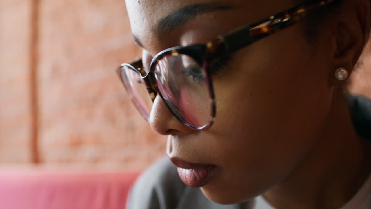 Close-up of a Woman Wearing Glasses in a Cafe