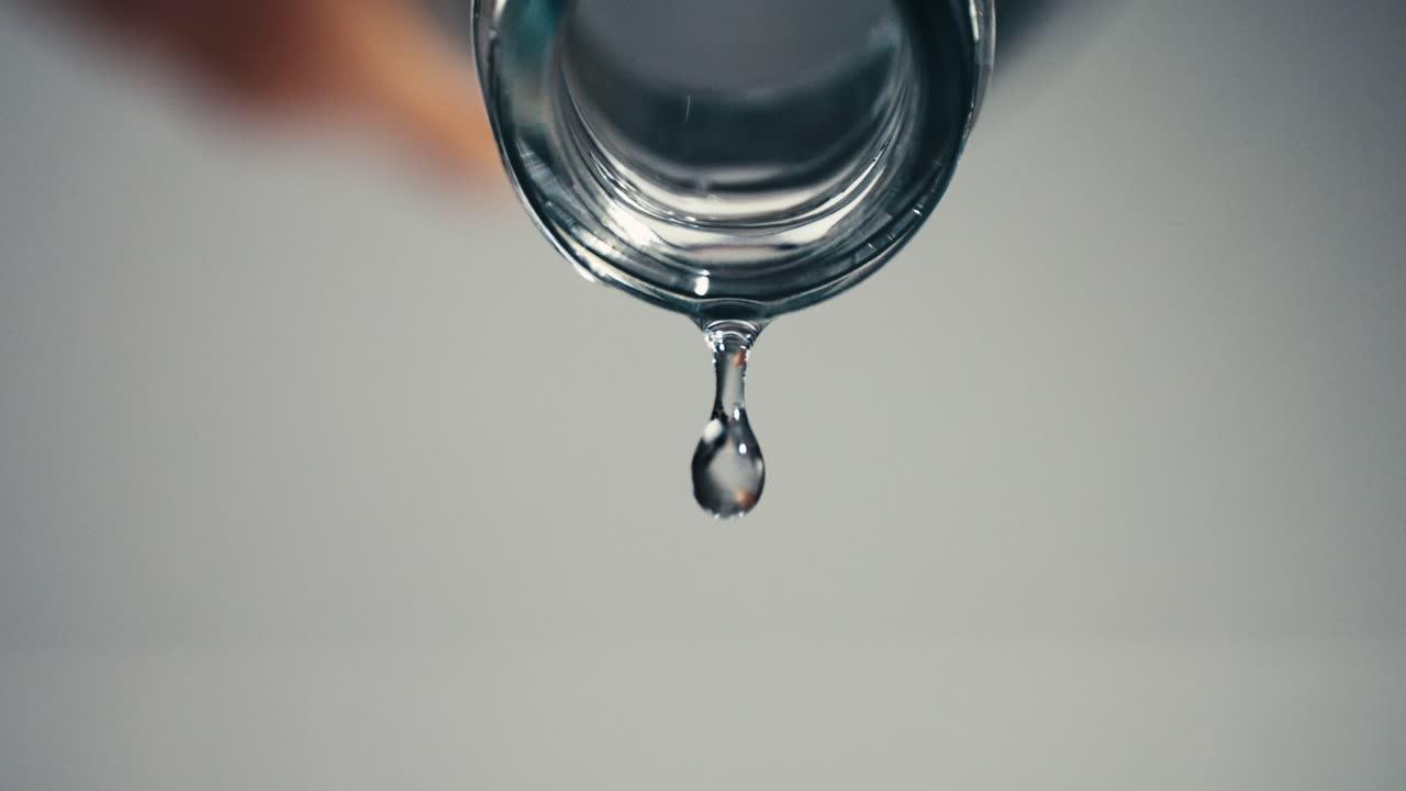 última gota de agua cayendo de una botella de agua, mantenerse hidratado, primer plano, alta velocidad, cámara lenta