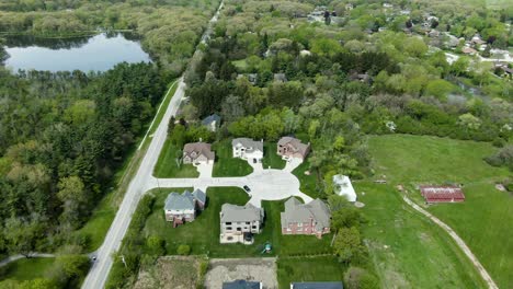 Several-modern-and-expensive-family-homes-on-a-not-so-busy-urban-road-near-a-local-forest-in-the-Midwest