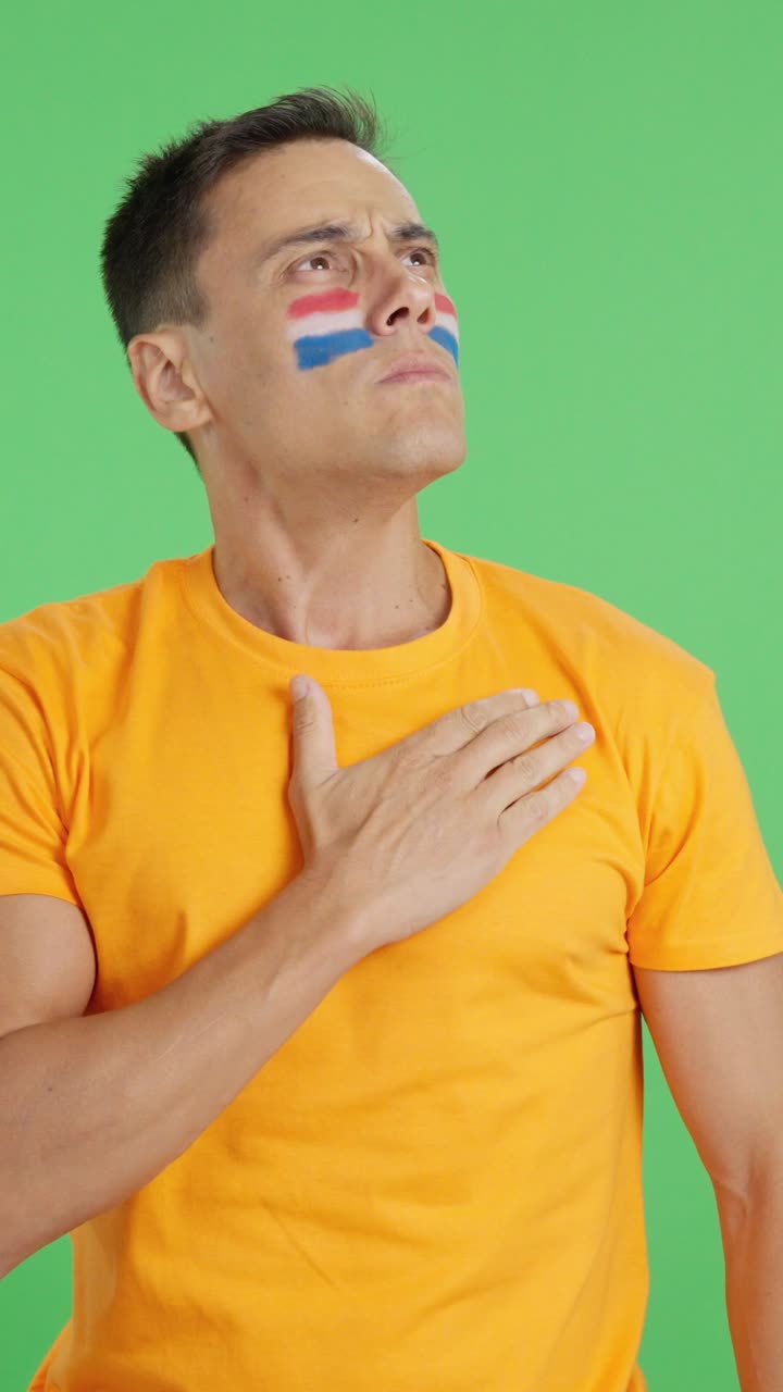 Man listening to the Holland national anthem with solemnity