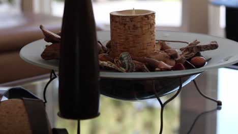 Close-up-shot-of-a-birch-candle-in-a-bowl