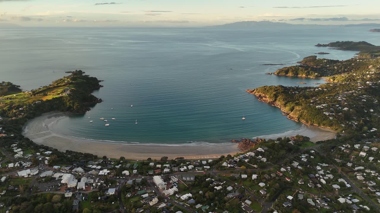 Oneroa town and beach at sunset, Waiheke Island, New Zealand. Aerial drone