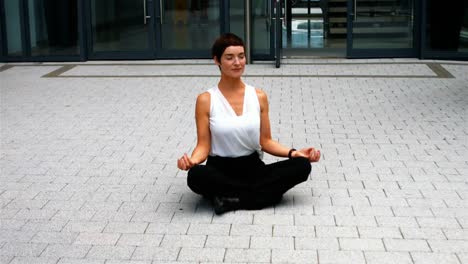 Businesswoman-performing-yoga