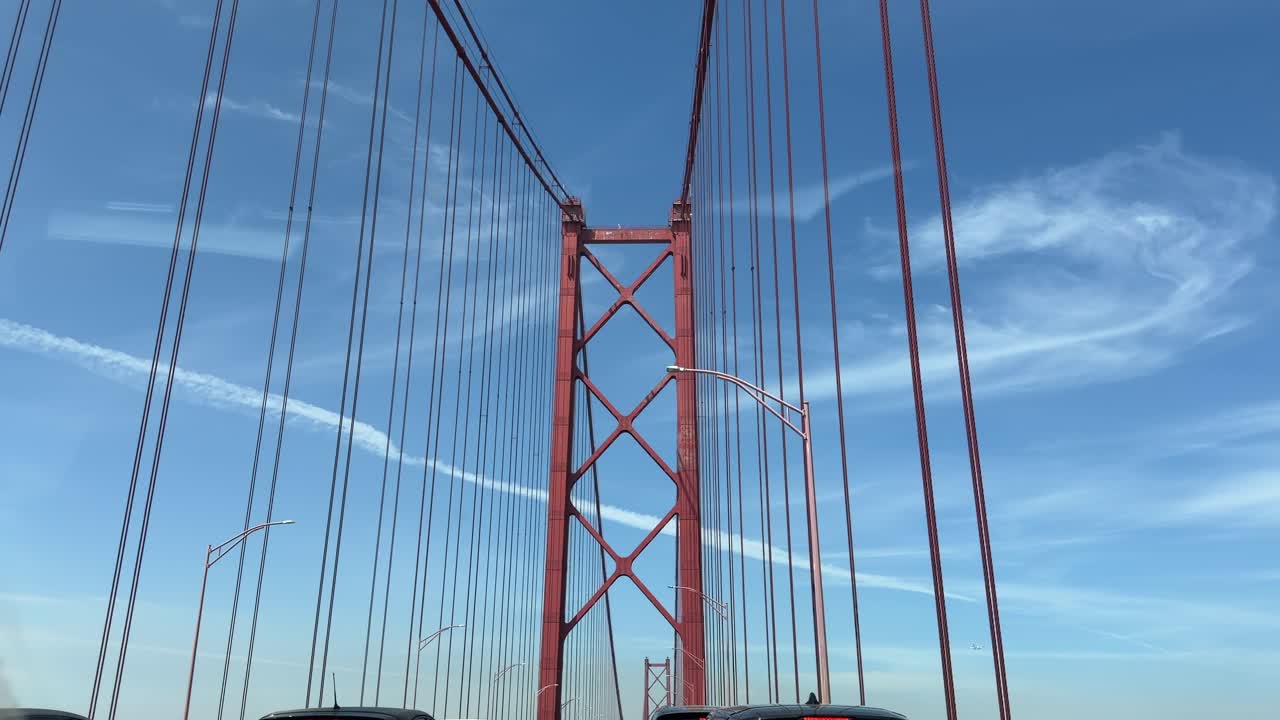 Driving Across a Red Suspension Bridge with a Passenger Filming