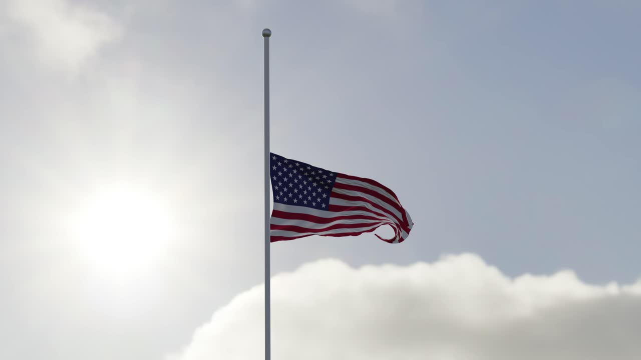 bandera de estados unidos a media asta en el viento