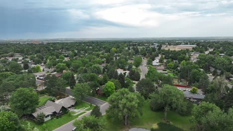 beautiful establishing shot for the town of greeley in th residential side of town beautiful lake in a park with trees flight over town