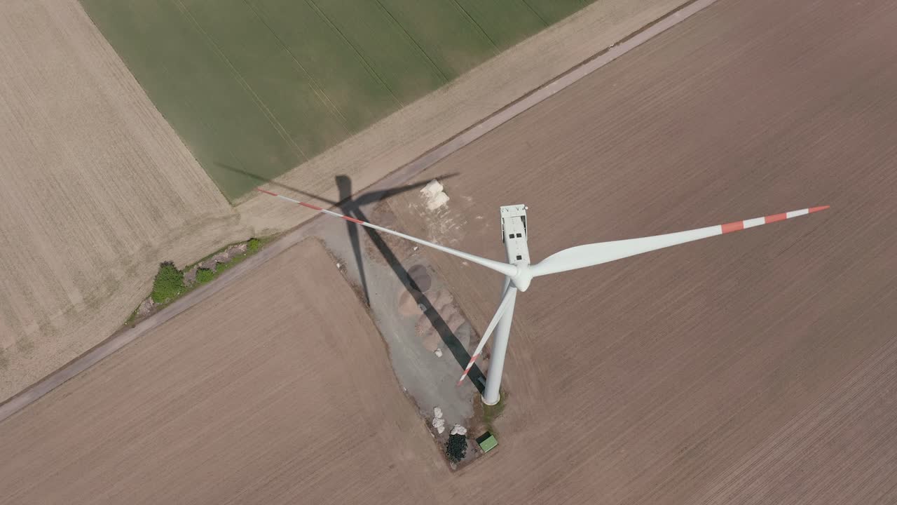 Aerial View Of Wind Turbine Generator At The Field On A Sunny Day