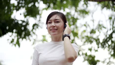 sporty woman listening to music with wireless headphones