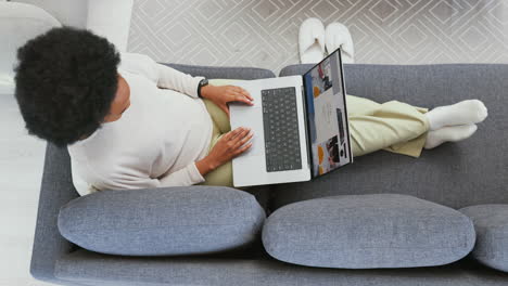 online shopping on laptop in home living room