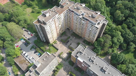 Large apartment Building by green park in Heidelberg, Germany, aerial