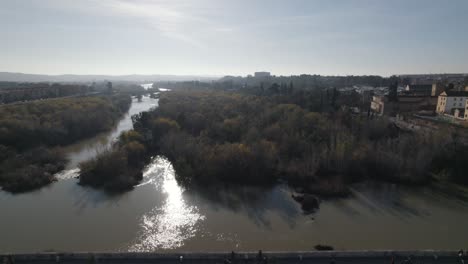 aerial pullback over roman bridge spanning guadalquivir; cordoba, spain