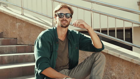 man sitting on stairs outdoors