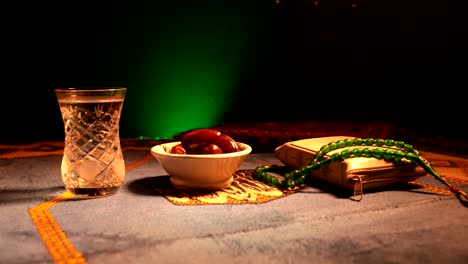 water and dates. iftar is the evening meal. slider view of decoration ramadan kareem holiday. festive greeting card, invitation for muslim holy month ramadan kareem. dark background. selective focus