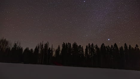 Night-star-sky-of-Milky-Way-roll-above-silhouette-of-forest,-fusion-time-lapse