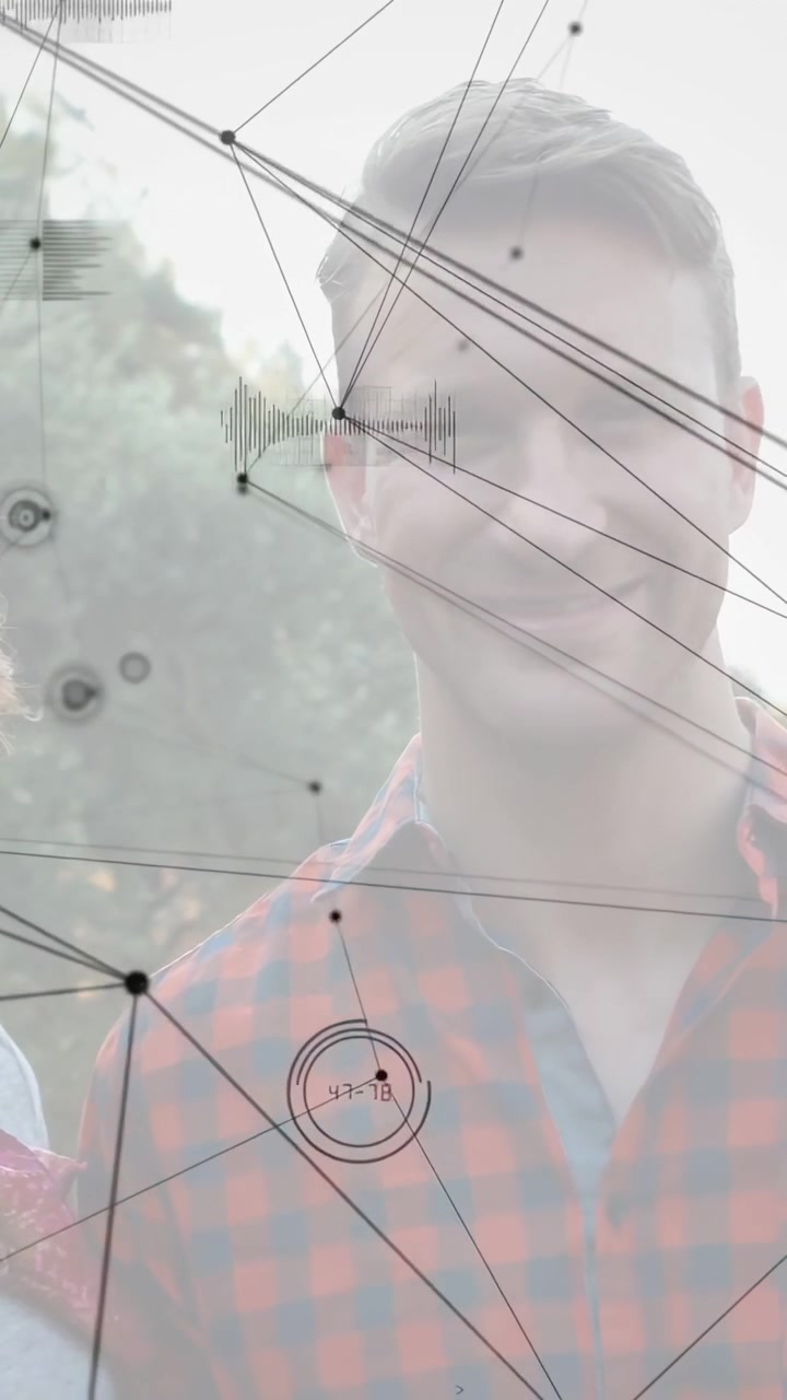 Couple standing outdoors smiling at camera while HUD graphics sweeping, mapping man's face