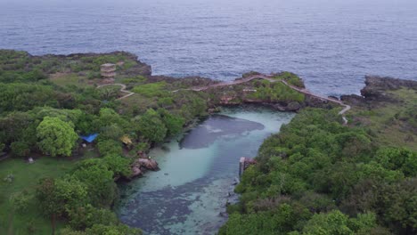 Flying-backwards-at-Waikuri-Lagoon-Sumba-with-no-people-during-sunrise,-aerial