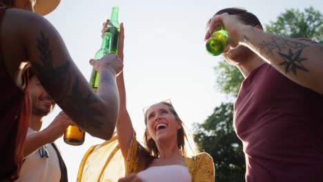 Low-angle-view-of-group-of-young-friends-spending-time-on-the-camper-side