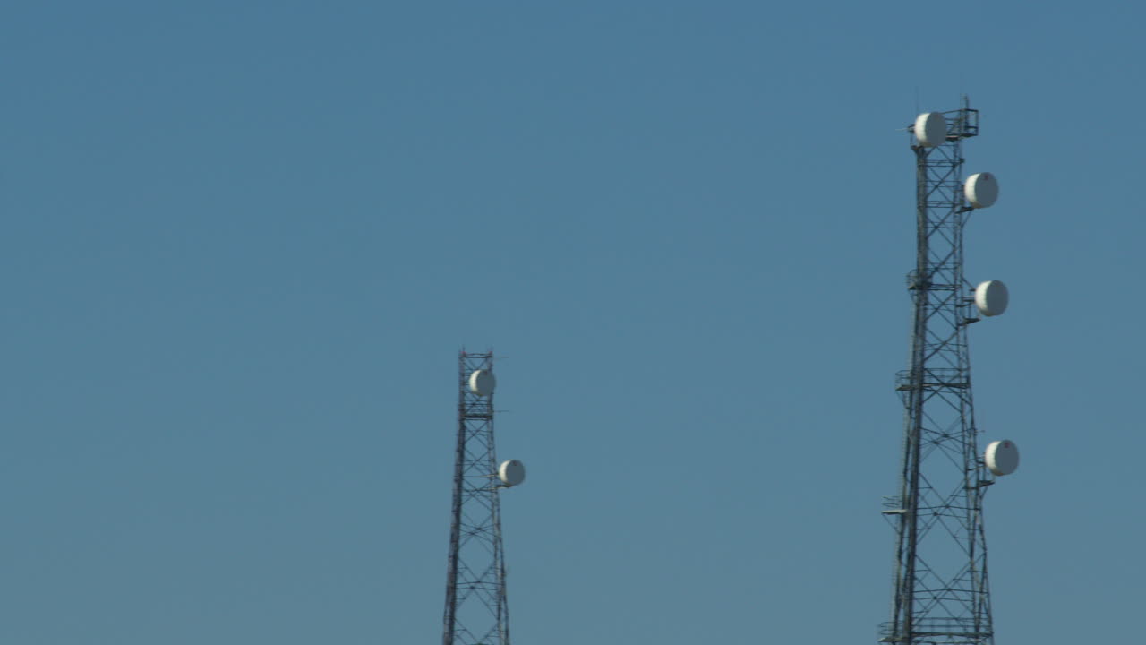Panning mid shot of shot of a communication mast tower at Bacton
