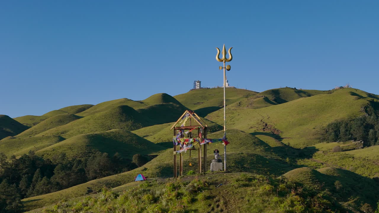 sacred Drone view of Lord Shiva's Trishul Trident Dolakha Sailung, Nepal green hill landscape with mountains and blue skies near Tibet, spiritual site ideal for peaceful camping and divine connection