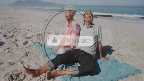 animation of speech bubble with thumbs up and like numbers over senior couple on beach