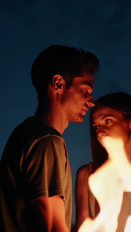 couple by firelight at night