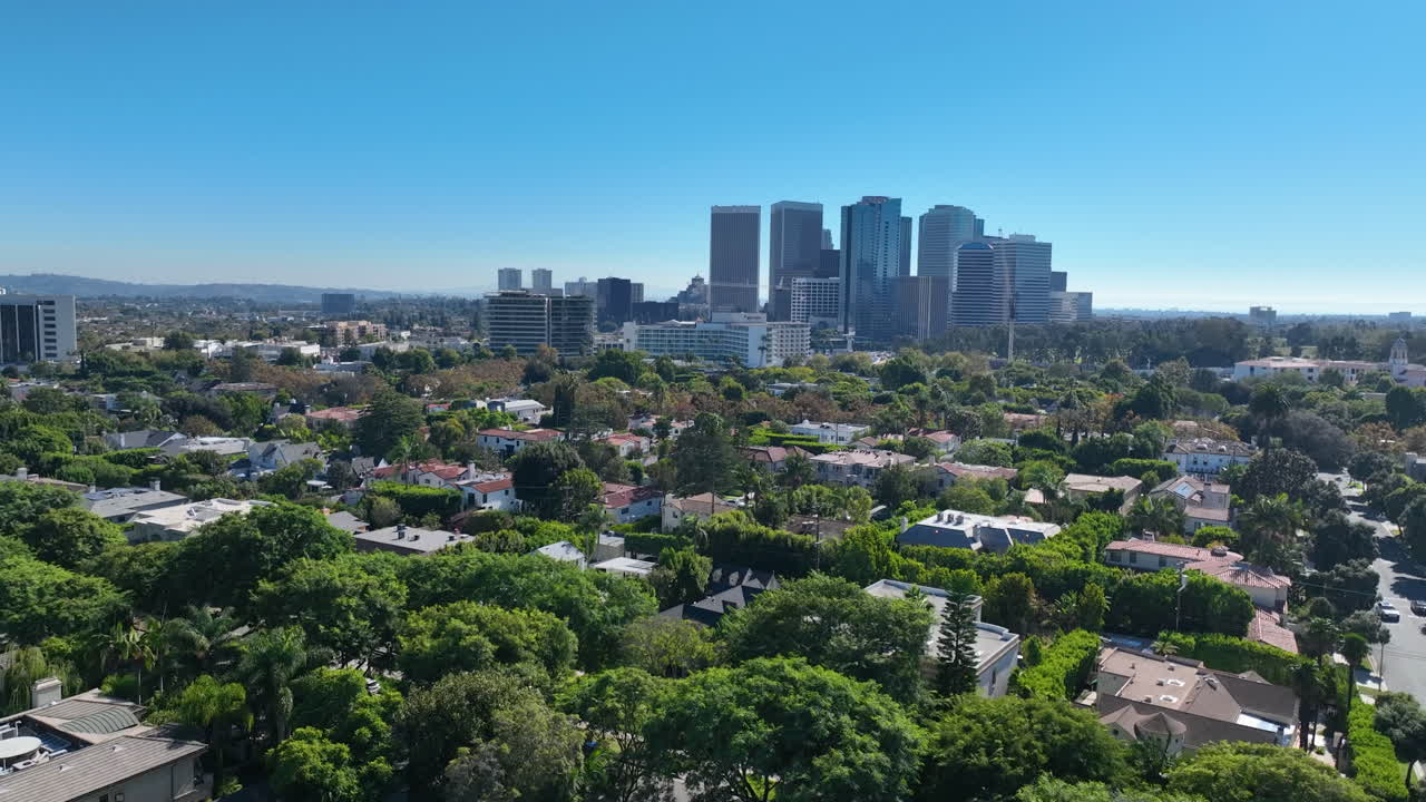 Aerial view over Beverly hills, Century city skyline background, in Los Angeles