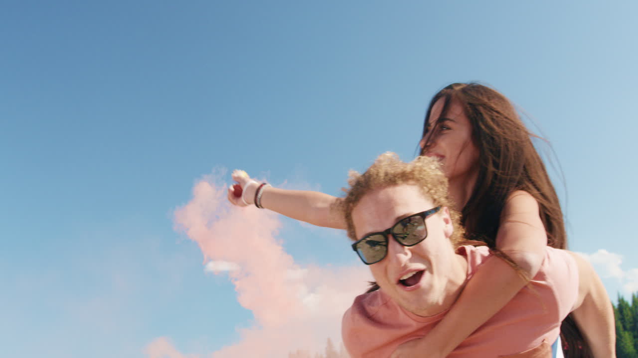 las parejas viajan a espaldas con humo rosado.