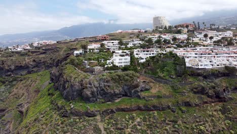 aerial drone view of residential and hotel complexes next to the coastline in northern tenerife, canary islands, spain
