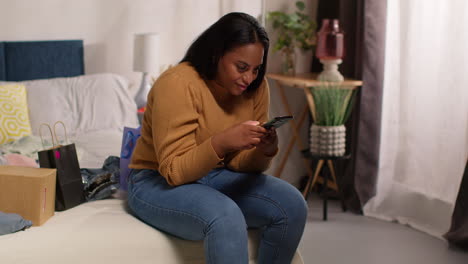 woman on bed texting