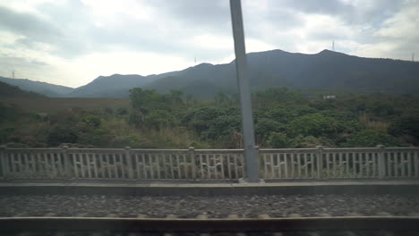 View-of-country-side-on-high-speed-rail-from-Hong-Kong-West-Kowloon-to-Chaoshan-in-China---train-enters-tunnel-at-end-of-video