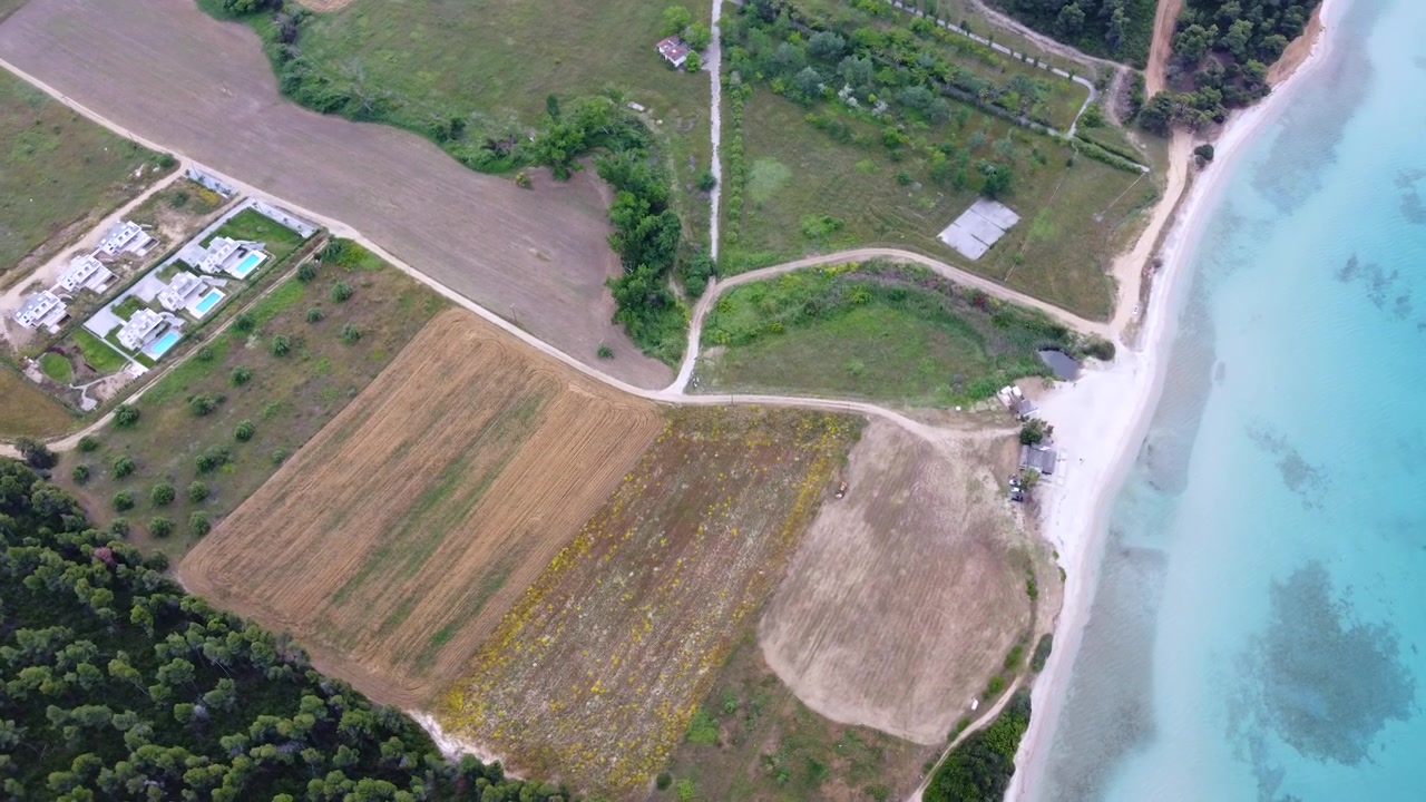 Turquoise Scenic Kassandra Coastline with Beach, Farmland, Forest and Luxury Villa in Greece Aerial View