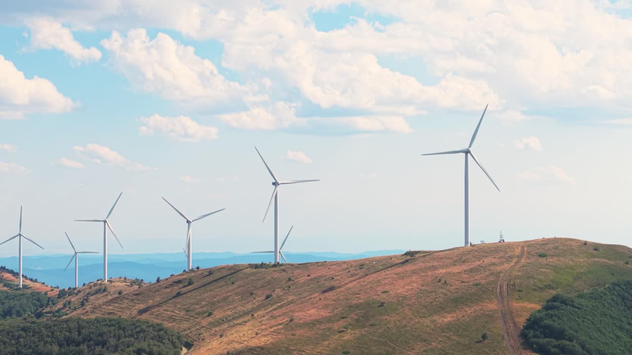 Drone shot of sustainable electricity production on forested slopes near Shipka. Green energy solution surrounded by clouds and mountain views