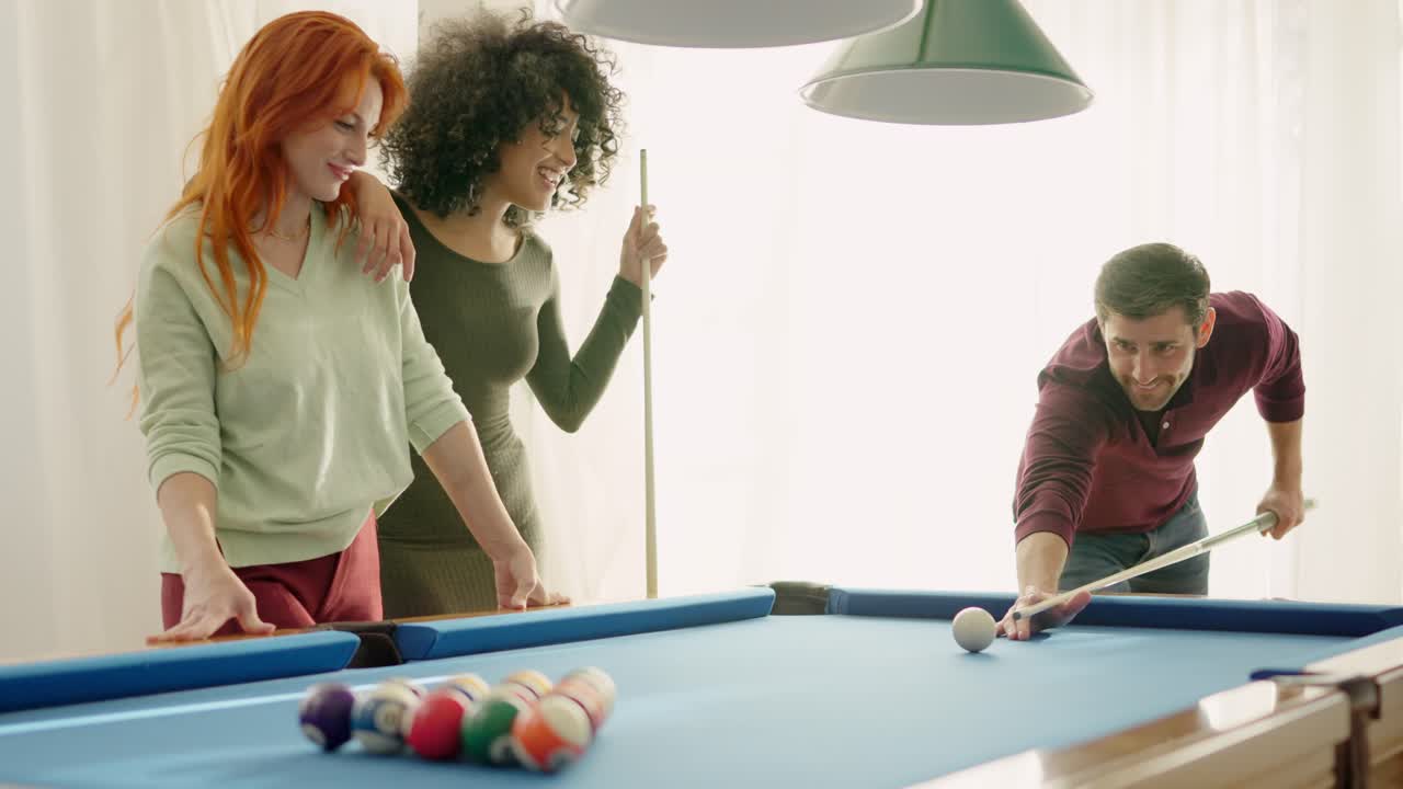 Man performing good shot in pool and women admiring him
