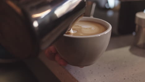 unrecognizable barista making big cup of cappuccino