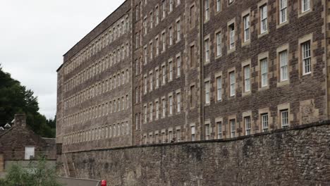 slow establishing shot of windows on old tenement buildings at new lanark