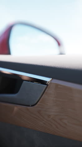 close-up of a car door handle with wood trim