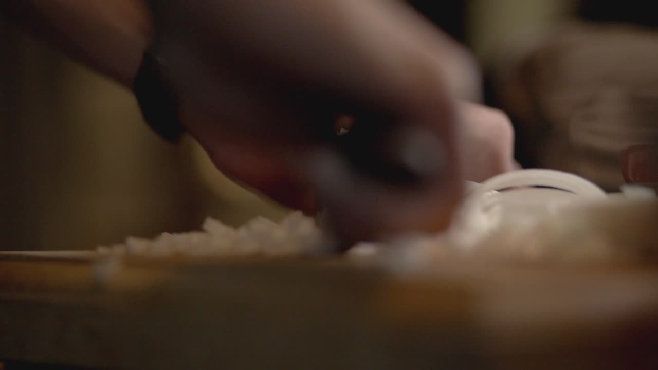 Cook Mincing White Onions Into The Wooden Chopping Board