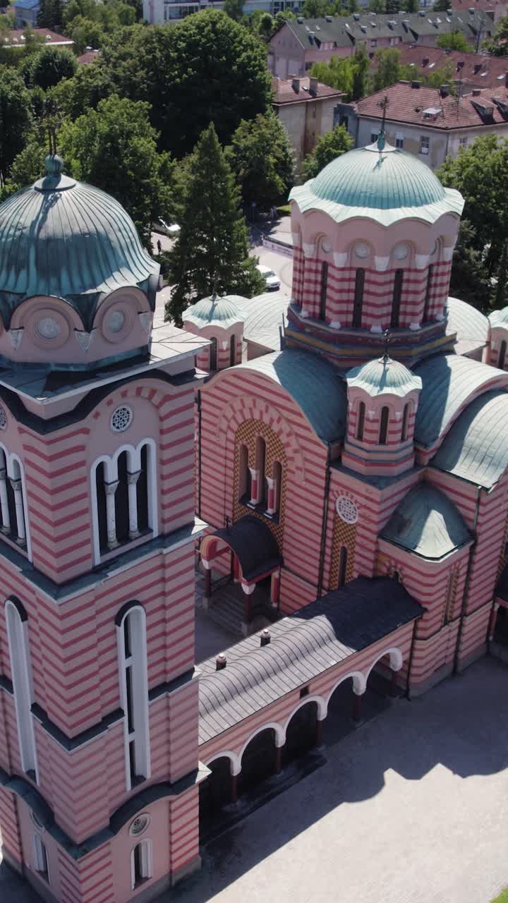 Elevated perspective of a historic orthodox church with intricate architecture and colorful details. Aerial, Vertical Video
