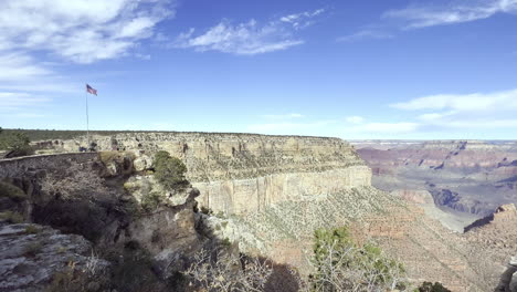 A-flag-of-the-United-States-of-America-waving-in-the-wind-overlooking-the-Grand-Canyon