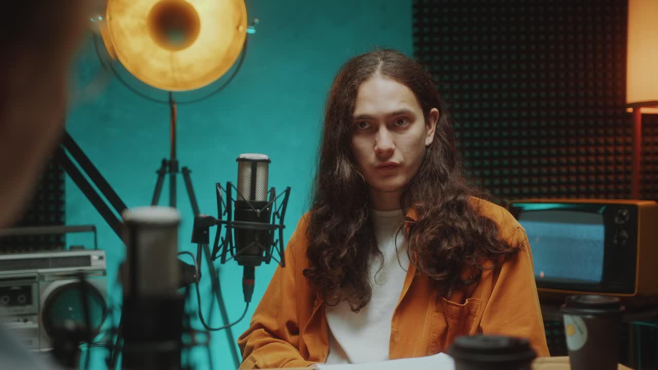 Young Guy Talking in Mic during Interview in Podcast Recording Studio