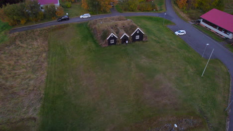 Blonde-woman-visiting-nordic-rural-farm-in-Hólar-Icelandic-village