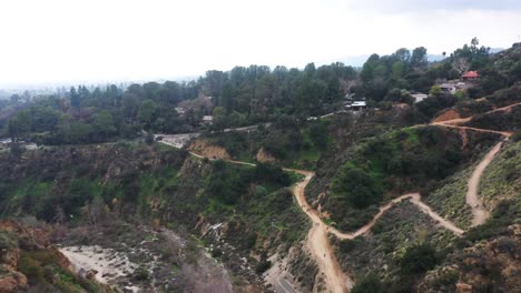 Aerial-landscape-reveal-shot-of-hikers-walking-on-the-trails-in-EatonCanyon-Falls-trail-in-Angeles-National-Forest-in-California