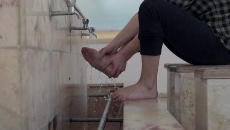 young muslim man taking ablution for prayer in mosque 6