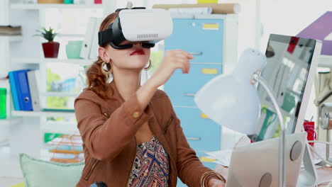 female executive working on laptop while using virtual reality headset 4k