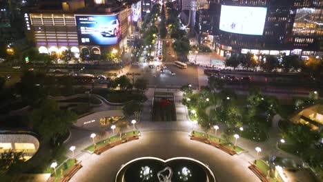 Night-aerial-of-Wulin-Square,-bustling-urban-square-located-in-the-Xiacheng-District-of-Hangzhou,-China