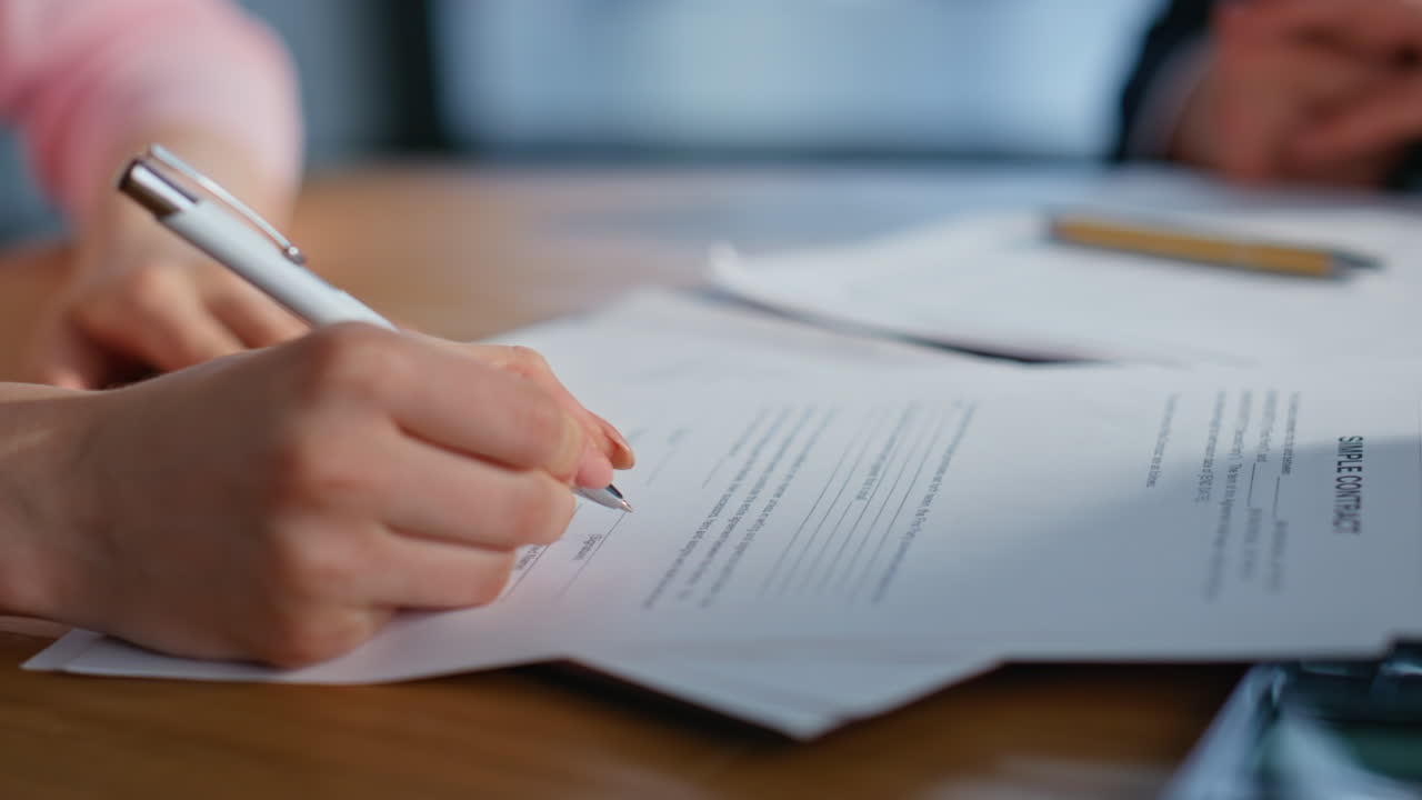 Corporate partner signing agreement at office desk closeup. Woman shaking hands