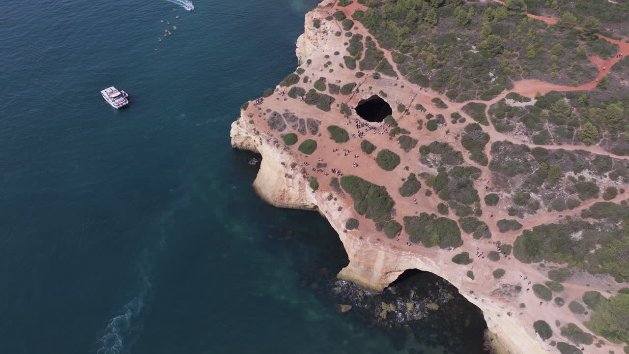 Beautiful cinematic aerial drone view of the Benagil Sea Cave and Atlantic Ocean coastline in Algarve, Portugal, Europe