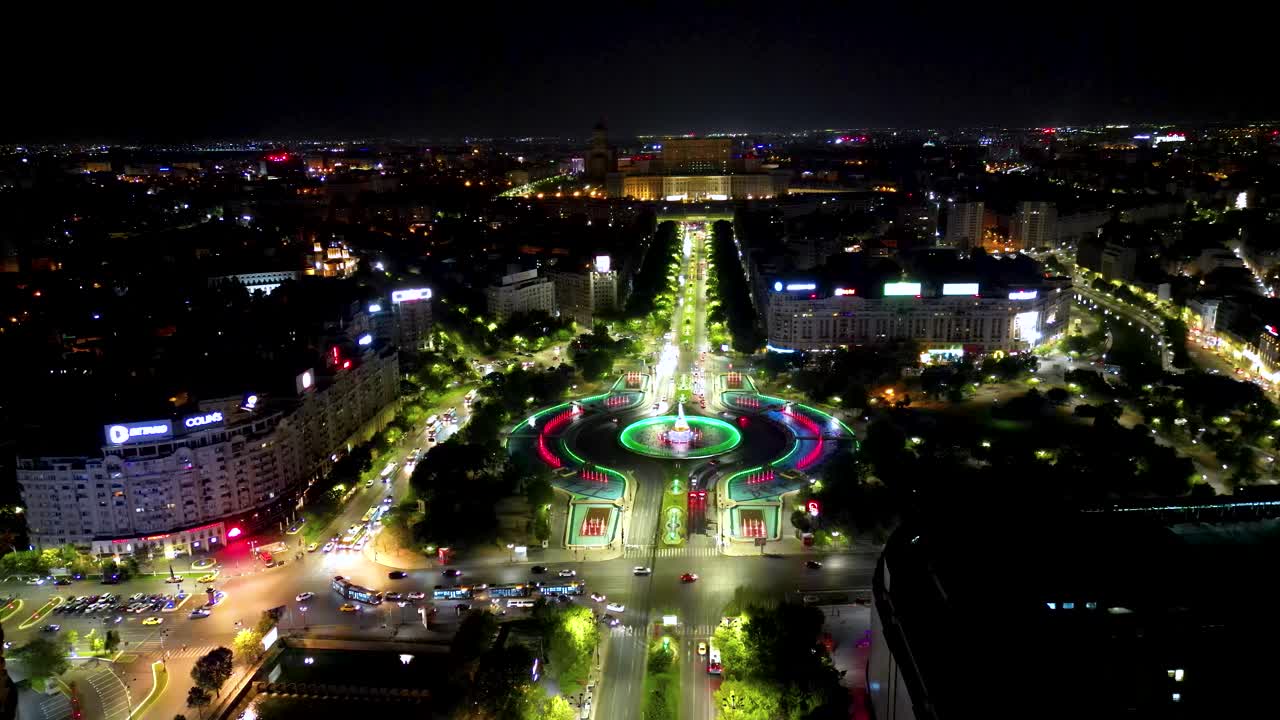 City center of Bucharest at night.Panoramic aerial perspective. Water fountains illuminated. Palace of the Parliament building in background. Static footage.