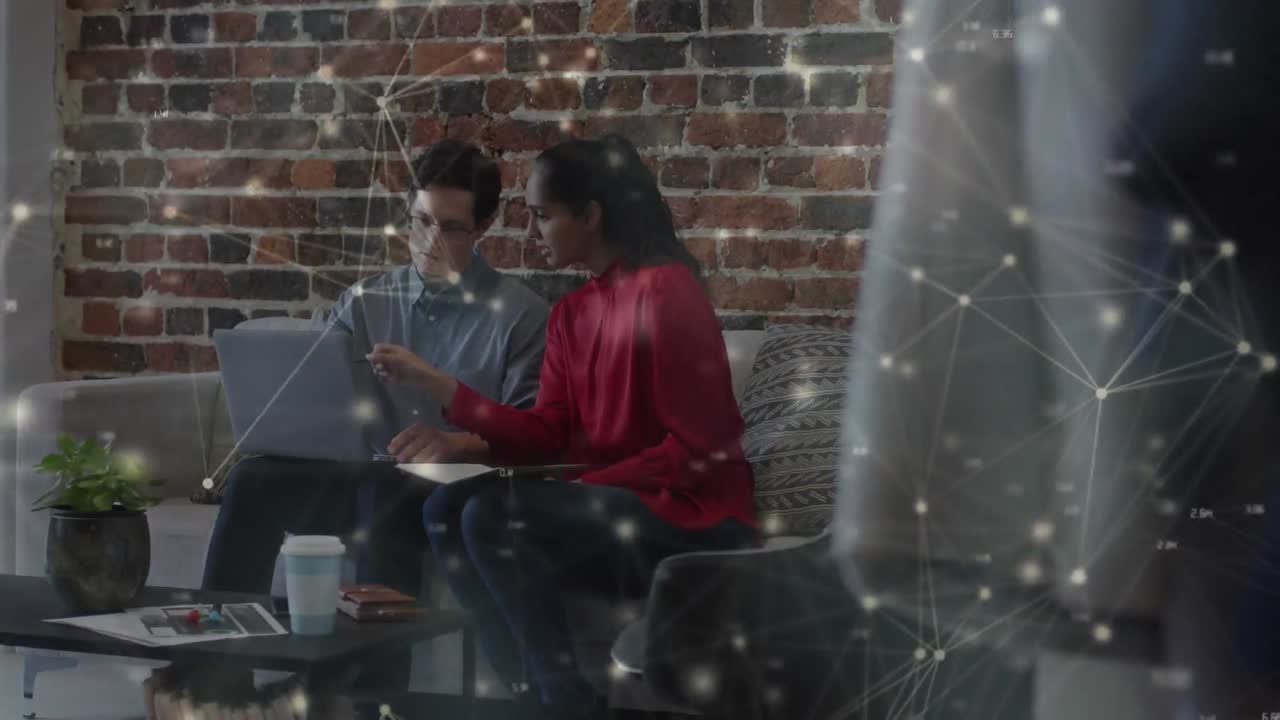 Animation of networks of connections over business people using laptop