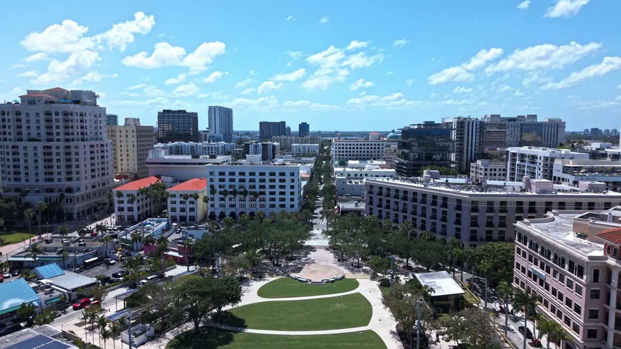 Aerial: downtown West Palm Beach cityscape with palm trees during the day in Florida, USA, dolly in drone shot